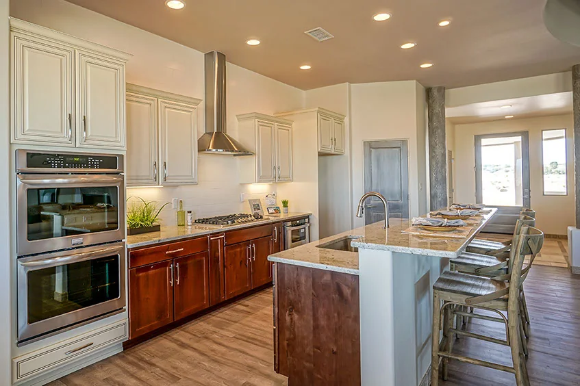 Kitchen with a broad island and warm wood cabinetry