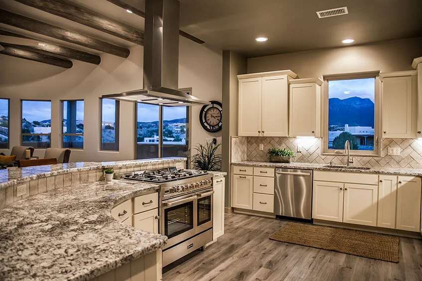 Kitchen island at the center of the gathering rooms