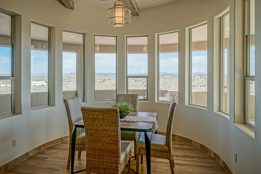 The rounded dining bay framed by windows