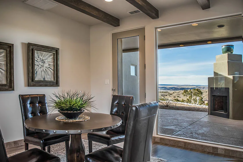 Dining area framed by broad windows