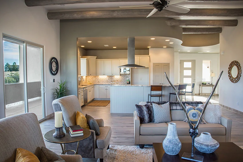 A bright Southwestern interior with vigas and softly curved openings