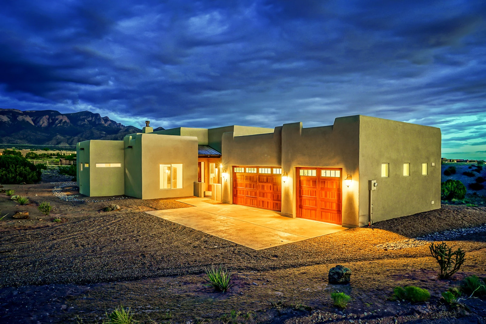 Mesa home exterior under a dramatic New Mexico evening sky